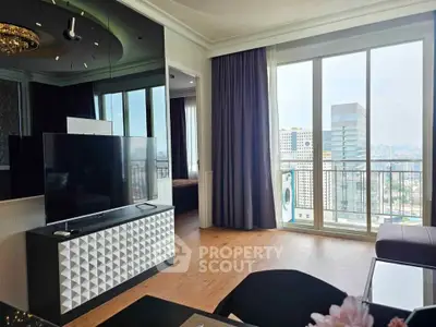 Modern living room with large TV and city view from balcony