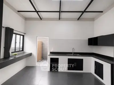 Modern kitchen with sleek black countertops and open layout design
