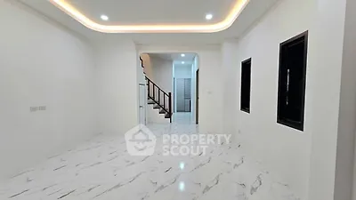 Spacious modern living room with elegant marble flooring and ambient lighting