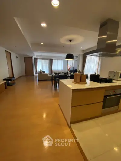Spacious open-plan living and kitchen area with modern design and ample natural light.