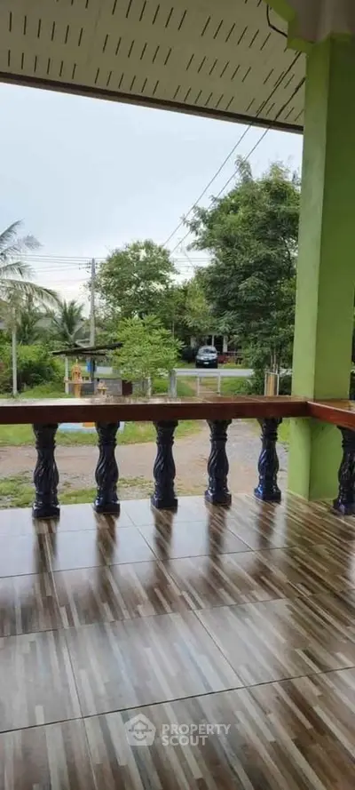 Charming balcony with tiled flooring and lush green view