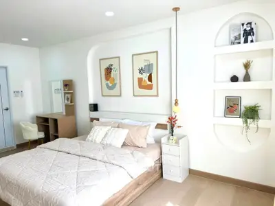 Modern bedroom with stylish decor and natural light