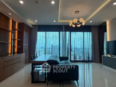 Luxurious living room with modern decor and stunning city view through large windows.
