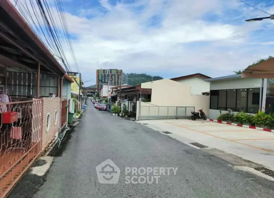 Charming residential street with diverse architecture and lush greenery, perfect for serene living.
