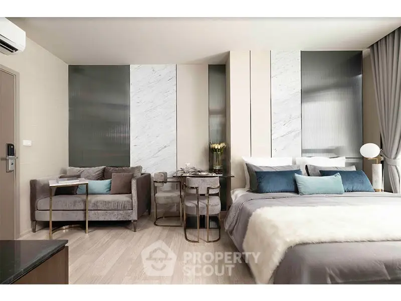 Luxurious modern bedroom with elegant decor and cozy seating area, perfect for relaxation and comfort.