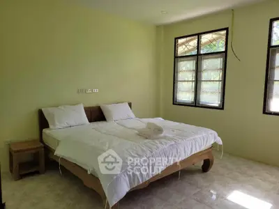 Spacious bedroom with large windows and natural light