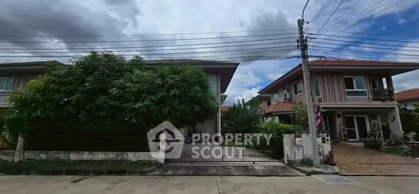 Charming suburban houses with lush greenery and clear skies.