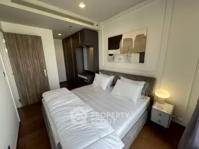 Modern bedroom with stylish decor and cozy ambiance, featuring a comfortable bed and elegant furnishings.