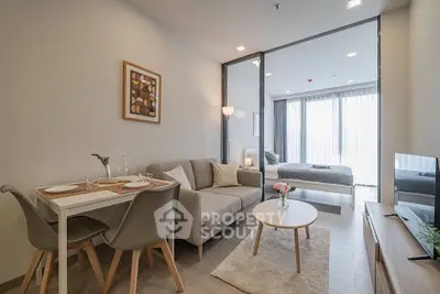 Modern open-plan living room and bedroom with stylish decor and natural light.