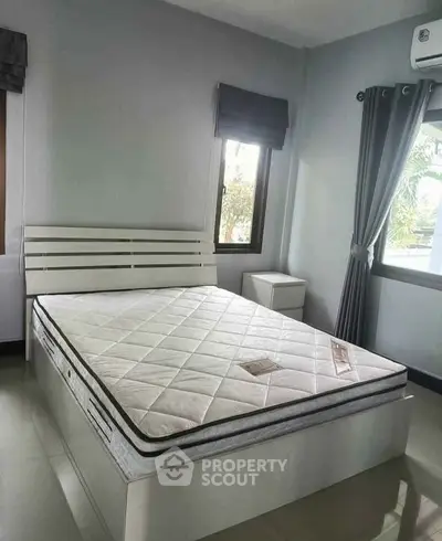 Modern bedroom with sleek design and natural light, featuring a comfortable mattress and stylish decor.