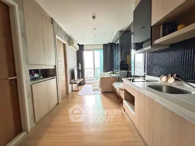 Modern open-plan living room with sleek kitchen and city view balcony.