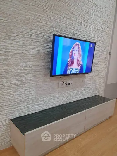 Modern living room with mounted TV and stylish textured wall