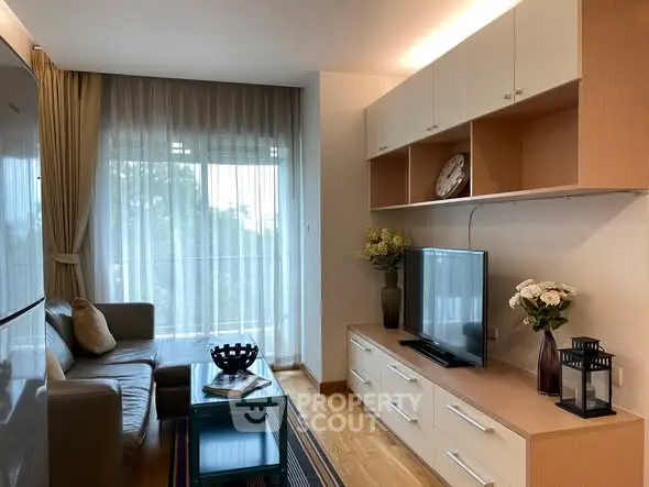 Stylish living room with modern decor, large window, and cozy seating area in a contemporary apartment.