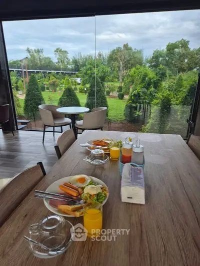 Stunning garden view from modern dining area with breakfast setup