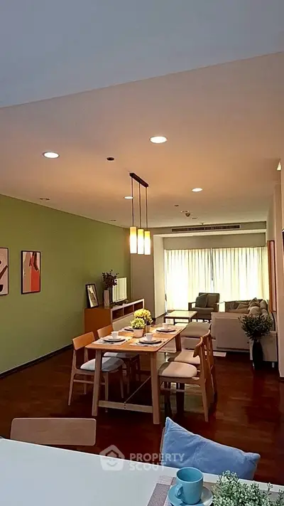 Spacious modern living room with dining area, stylish decor, and ample natural light.