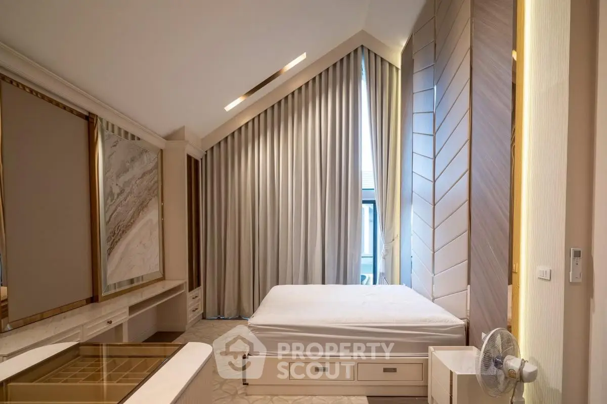 Luxurious modern bedroom with high ceiling and elegant decor