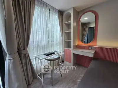 Chic study area with modern desk and elegant curtains in a cozy room.
