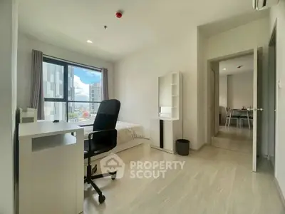 Modern bedroom with city view, featuring a study desk and sleek decor.