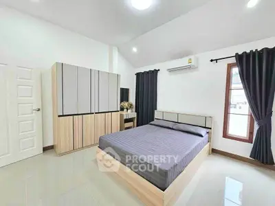 Modern bedroom with sleek design and ample natural light