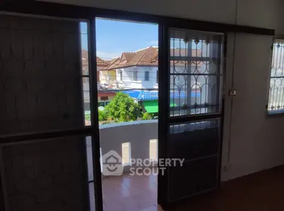 Charming balcony view with traditional rooftops and sunny skies, perfect for a cozy home setting.