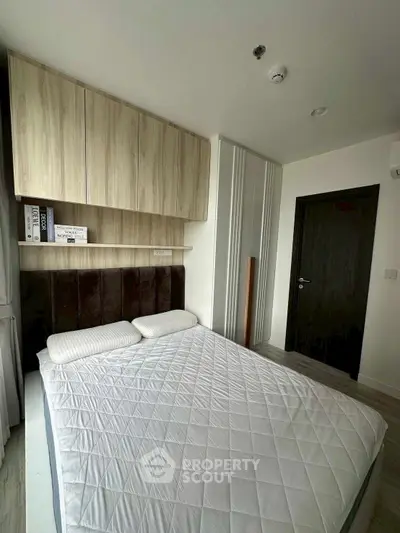 Modern bedroom with stylish wooden cabinets and cozy bed setup