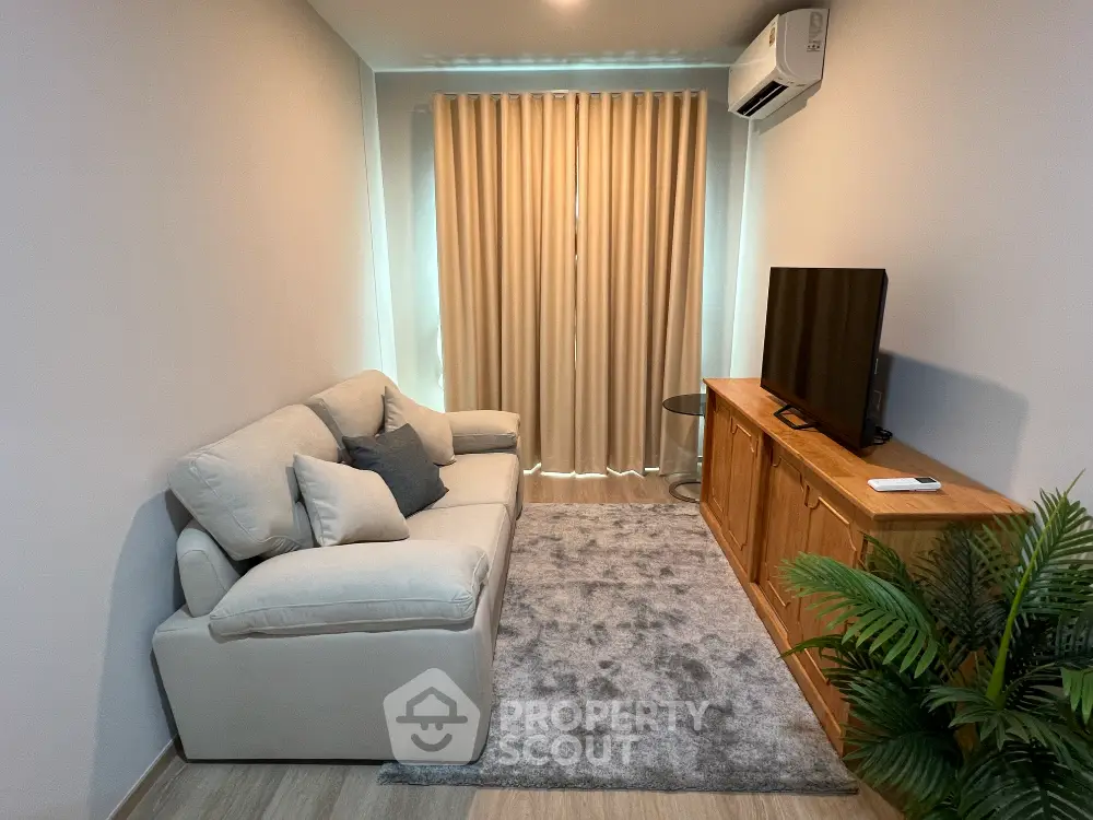 Cozy living room with modern sofa, TV, and elegant decor