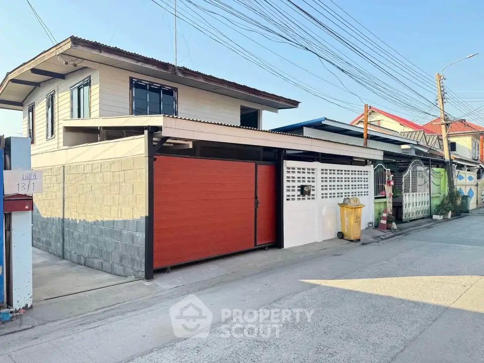 Charming two-story house with modern facade and spacious driveway in a quiet neighborhood.
