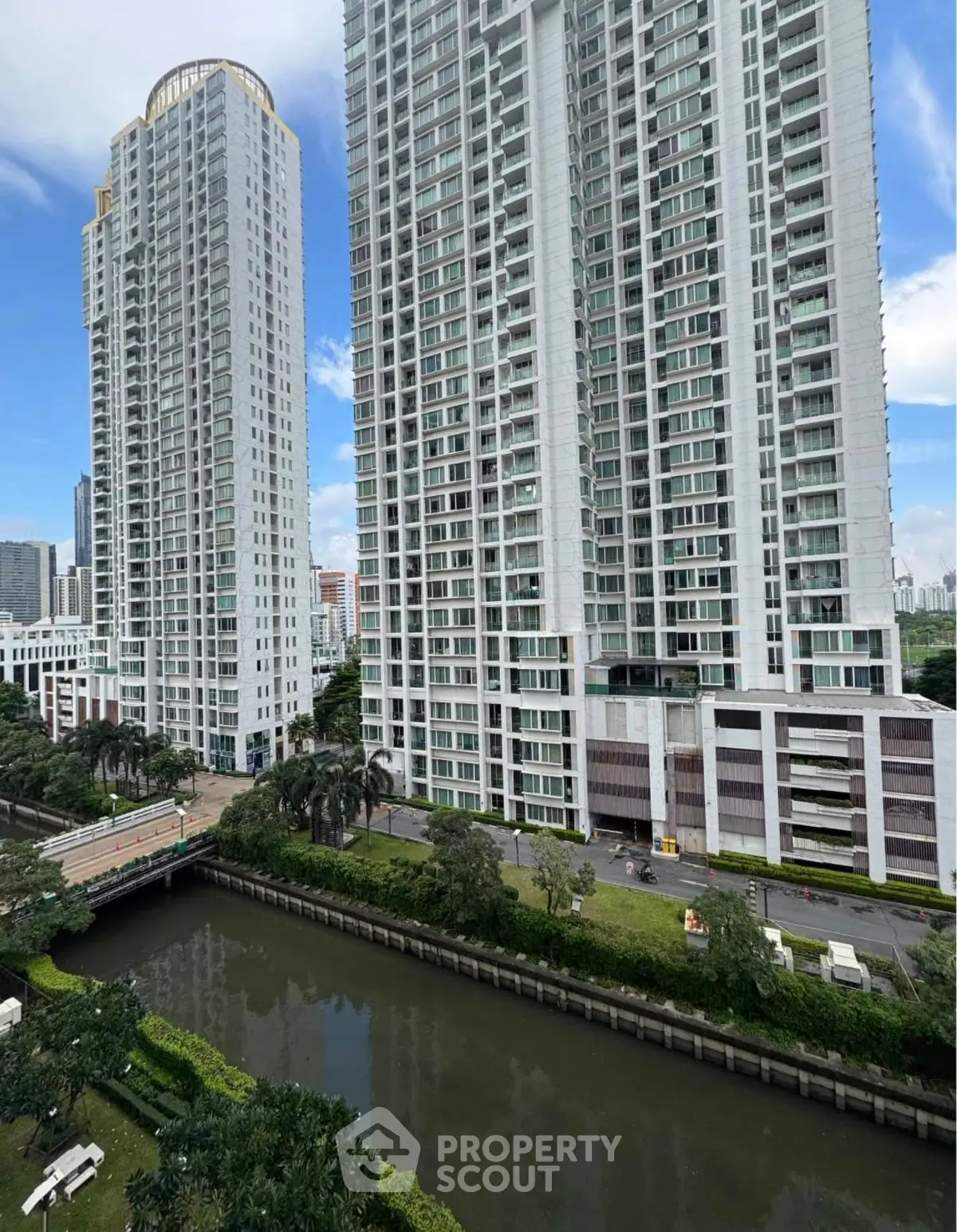 Stunning high-rise residential buildings with lush greenery and canal view.