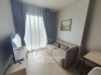 Cozy living room with modern decor, featuring a comfortable sofa, flat-screen TV, and elegant curtains.