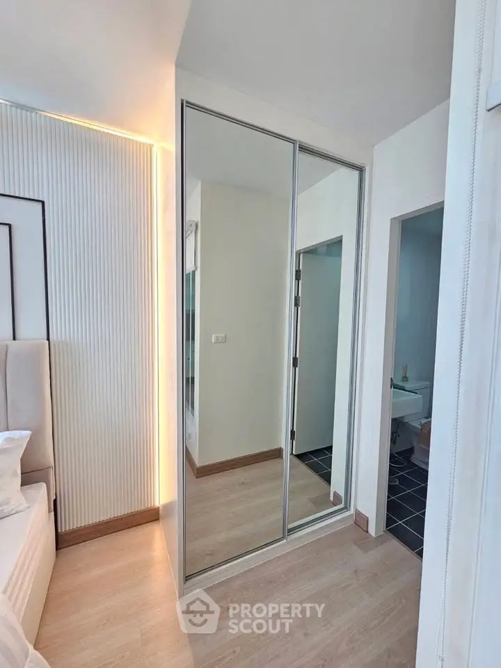Modern bedroom with mirrored closet and sleek design