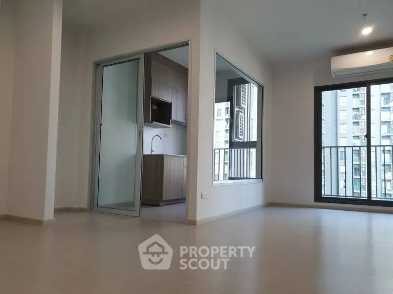 Modern apartment interior with open layout and balcony view