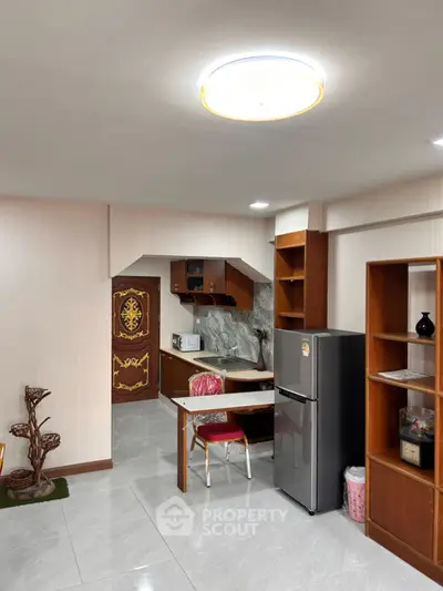 Cozy kitchen with modern fridge and elegant wooden cabinetry