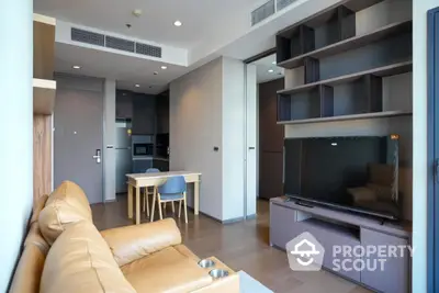 Modern living room with open kitchen and stylish furniture in a contemporary apartment.