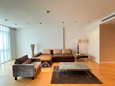 Spacious modern living room with stylish furniture and wooden flooring