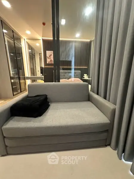 Modern living room with sleek gray sofa and stylish decor