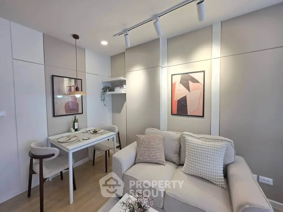 Modern living room with cozy sofa and dining area, featuring stylish decor and soft lighting.