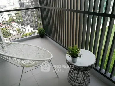 Modern balcony with stylish chair and table overlooking cityscape
