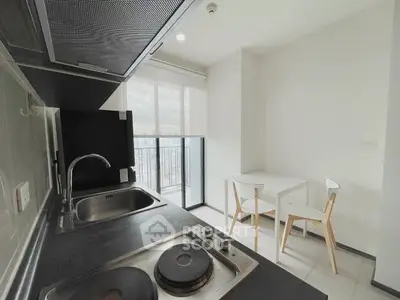 Modern kitchen with sleek design and city view balcony access