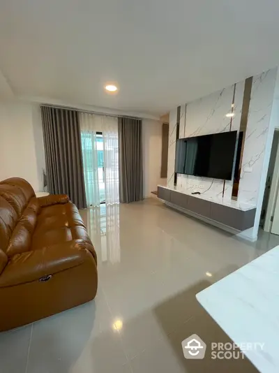 Modern living room with sleek TV setup and elegant marble accents