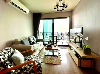 Stylish living room with balcony view, modern furniture, and elegant decor in a cozy apartment.