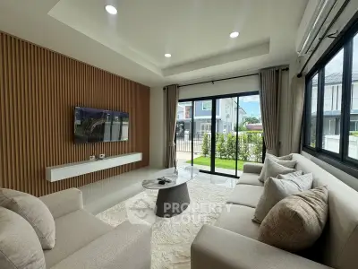 Modern living room with large windows and stylish furniture in a contemporary home.