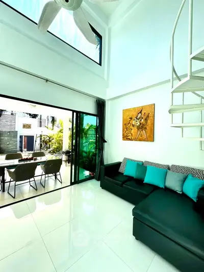 Luxurious living room with spiral staircase and garden view, featuring modern decor and abundant natural light.