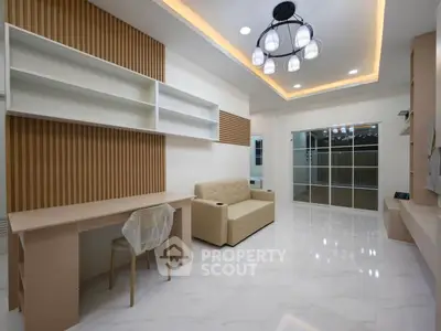 Modern living room with stylish lighting and sleek furniture in a contemporary home.