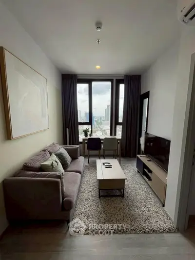 Modern living room with city view, cozy sofa, and stylish decor in high-rise apartment.