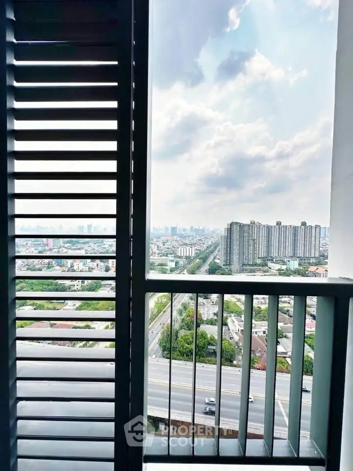 Stunning cityscape view from a high-rise balcony with modern railing design.
