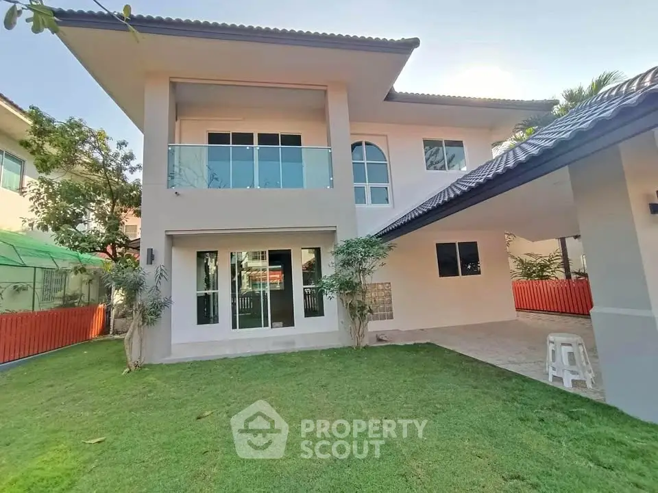 Spacious two-story house with modern design and lush green lawn