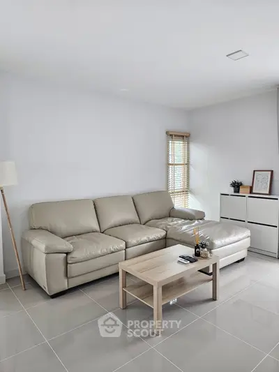 Modern living room with beige leather sofa and sleek decor