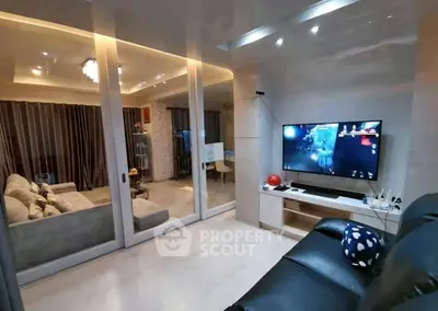 Modern living room with sleek design and entertainment setup, featuring cozy seating and ambient lighting.