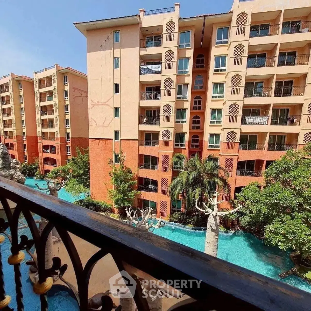 Stunning apartment complex with pool view and lush greenery
