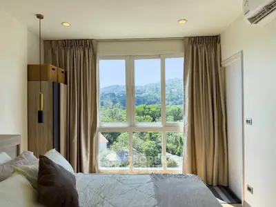 Bright bedroom with large window offering stunning mountain views
